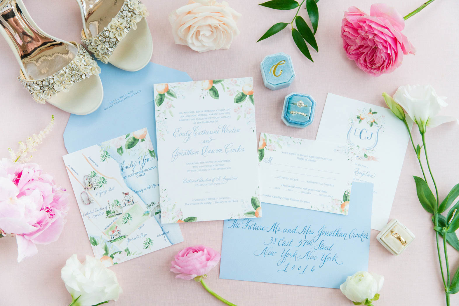 pink and light blue wedding invitation suite styled with flowers, rings + bride's shoes