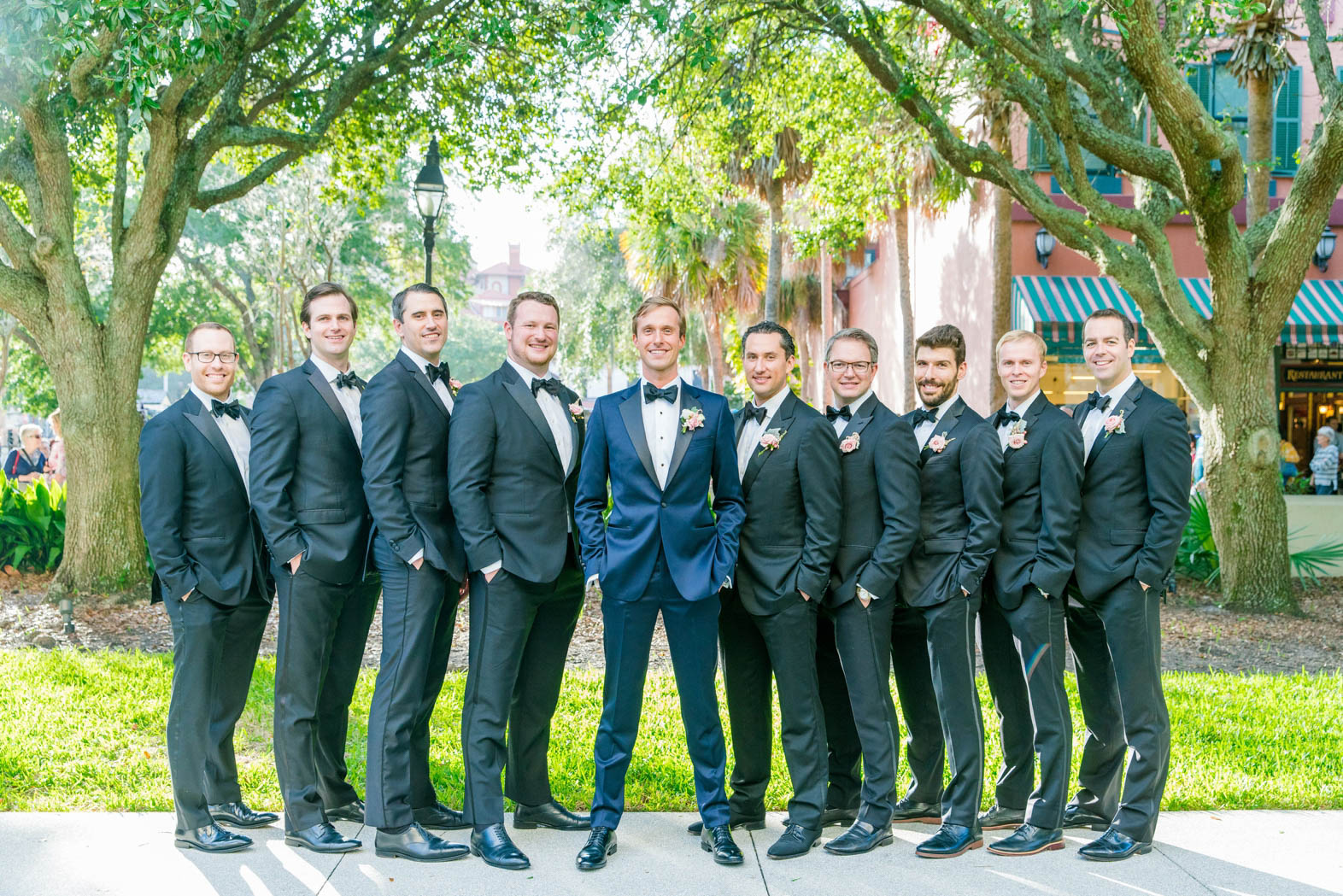 groom in navy tuxedo, groomsmen in black tuxedos