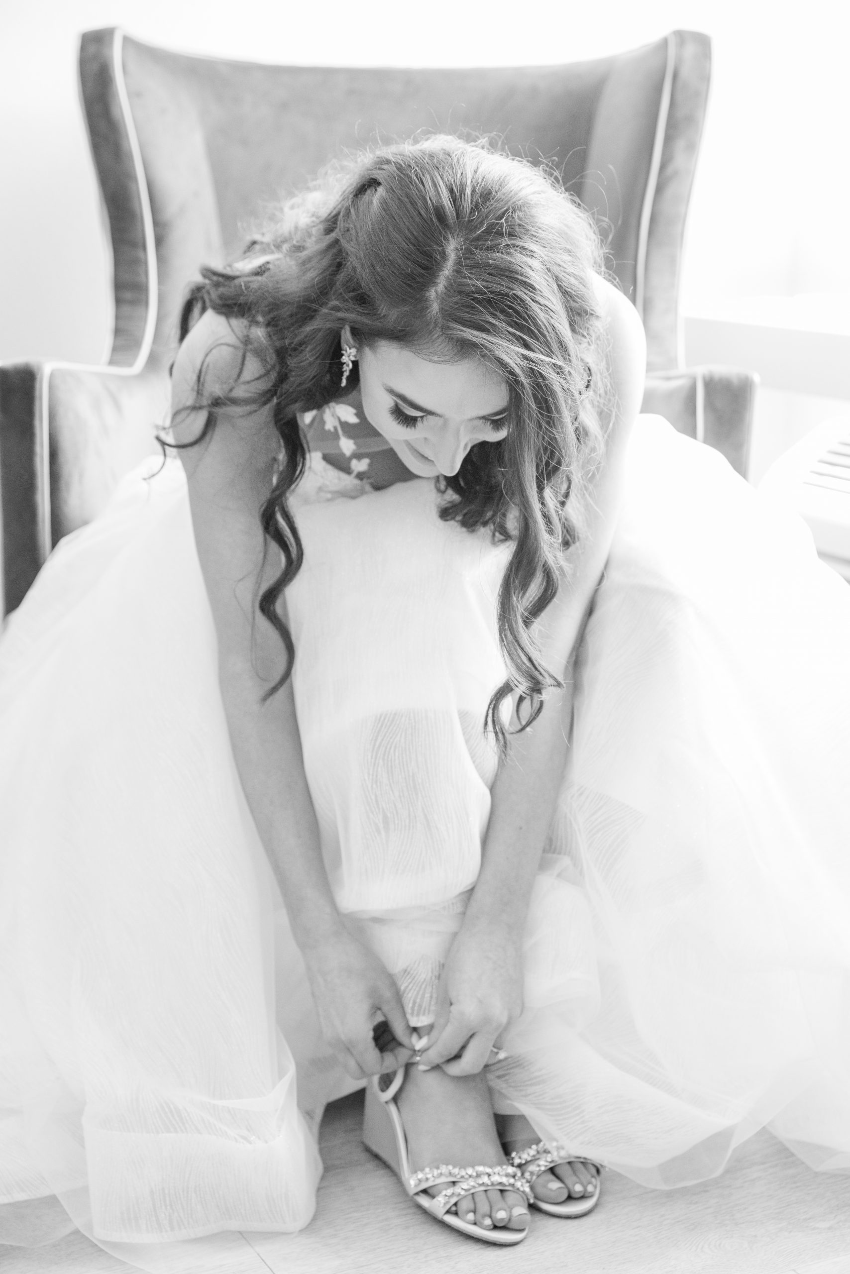 bride putting on shoes on her charleston wedding day